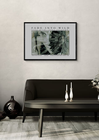 fade into wild by hazelart in a black frame on a pale wall above a dark sofa with candlesticks