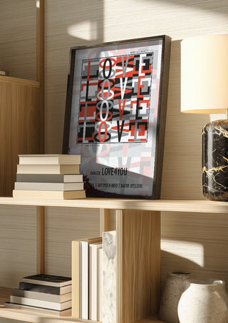 Danger Love4you - Type Signal by Amadeus Fuchs in a dark frame on a wooden shelf beside books and a lamp