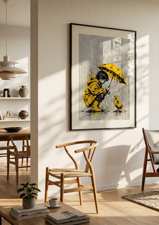 A Little Shelter by Matthews Gallerie in a black frame in a bright dining room with wooden chairs