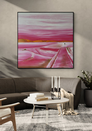 Pink Winter by Emil Walli in a black frame on a grey wall above a dark sofa with candlesticks