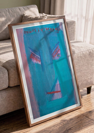 The Joy - De Vreugde by Motaz Nader in a walnut frame leaning against a grey sofa