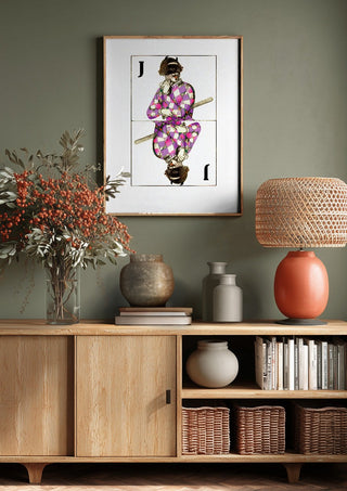 Joker by Bent Hardervig above a wooden sideboard on a sage green wall