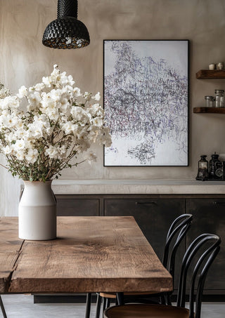 Nike by Priit Ruttas in a black frame above a rustic table with white flowers