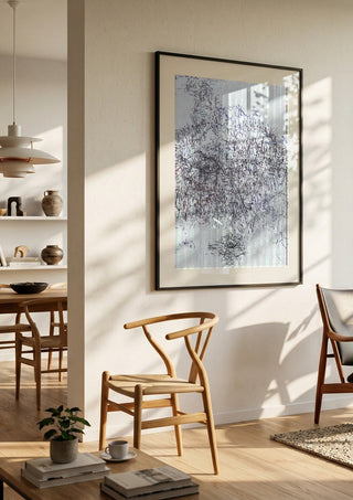 Nike by Priit Ruttas in a black frame in a bright dining room with wooden chairs