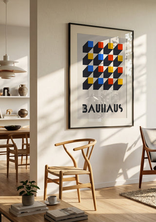 Bauhaus Grid by Neil Stevens in a black frame in a bright dining room with wooden chairs
