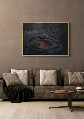 Decay (3) by Lone Gjessing in a light oak frame on a warm grey wall above a brown sofa