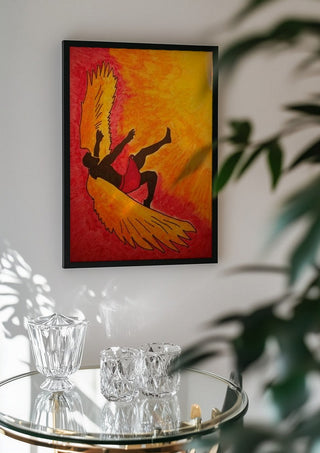 Manie oder der Flug des Ikarus by Olaf Baier in a black frame above a glass table with crystal glassware