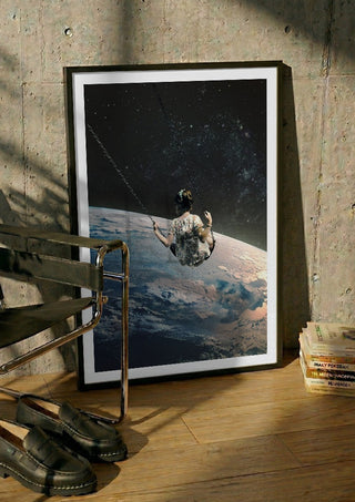 Swing by Fran Rodriguez in a black frame leaning against a concrete wall by a steel chair