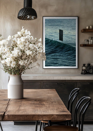 Deep Blue by Fran Rodriguez in a black frame above a rustic table with white flowers