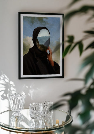 The Mountain Within by Fran Rodriguez in a black frame above a glass table with crystal glassware