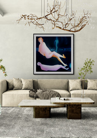 Contact #1 by Luis Valquaresma in a black frame above a beige sofa under a branch chandelier
