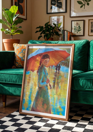 Woman with an Orange Umbrella by Mariia Nikolina in a wooden frame leaning against a green velvet sofa on a chequered floor