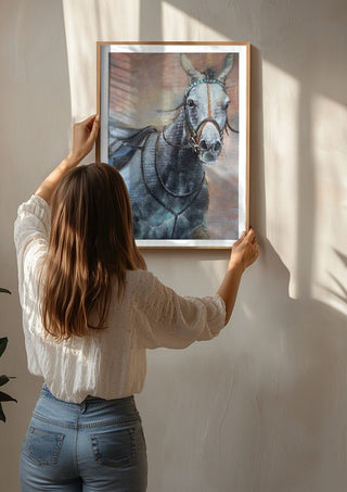 The Grey Horse by Mariia Nikolina being hung on a sunlit wall
