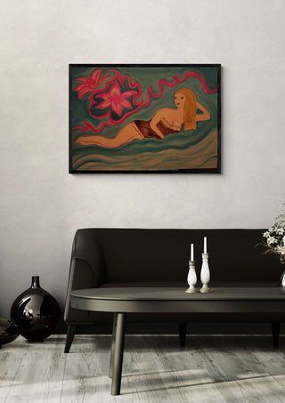 Lying Blonde by Carmen Coduri in a black frame above a dark sofa with candlesticks