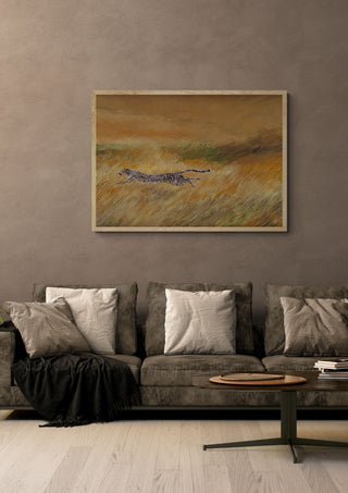 Plus vite que le vent by GAHO in a pale wooden frame above a grey sofa with cushions