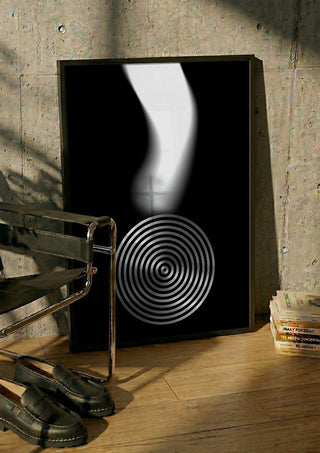 Echo by Aleksi Allan in a black frame leaning against a concrete wall by a steel chair