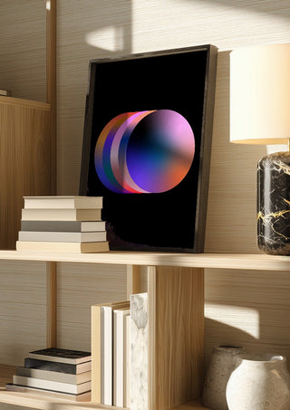 Layers by Aleksi Allan in a dark frame on a wooden shelf beside books and a lamp