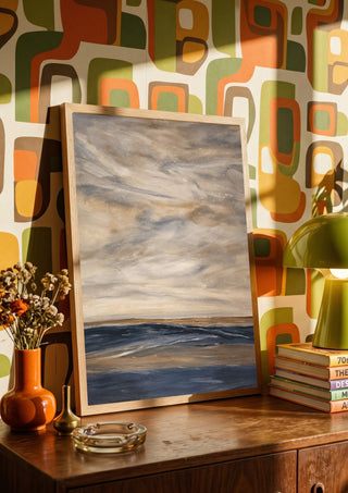 Whispers of Silence by Maya in a wooden frame on a sideboard against a retro patterned wall