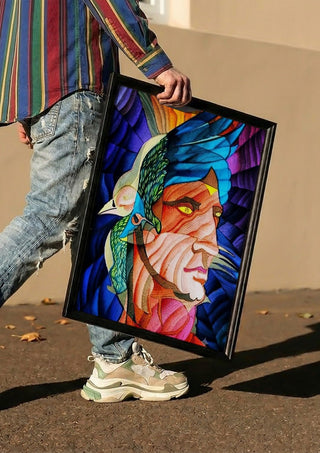 Adonis by Carlos Enrique Gozalo Ara carried in a black frame along a sunny street