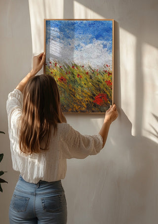 Coquelicots by GAHO being hung on a sunlit wall