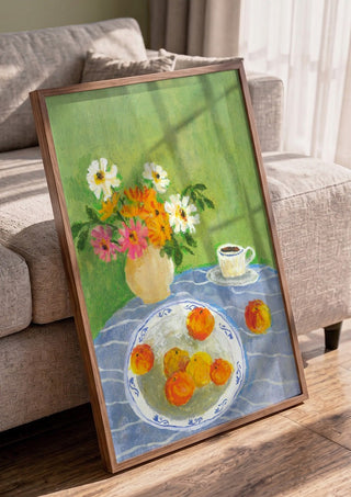 February Zinnias by Deblina Dey in a walnut frame leaning against a grey sofa