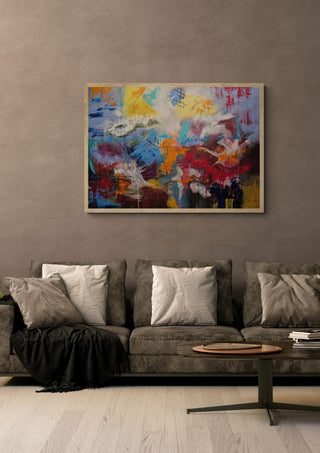 Symphony of colour by Sabine Halbrock in an oak frame above a grey sofa with cushions