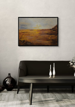 When the Light Grows Quiet by Sabine Halbrock in a black frame above a dark sofa with white candlesticks