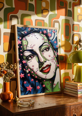 StarLady by Okiana in a wooden frame on a sideboard against retro patterned wallpaper