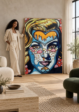 Marylin Monroe by Okiana leaning against a sunlit living room wall beside a woman