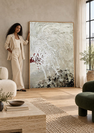 Pain by Tonia leaning against a sunlit living room wall beside a woman