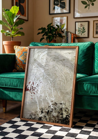 Pain by Tonia in a wooden frame beside a green velvet sofa on a chequered floor