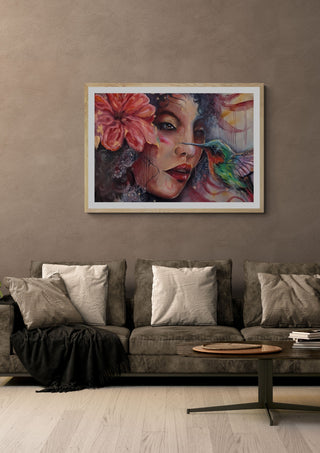 The Light Moment by Elisa Kay in a white frame above a grey sofa with cushions