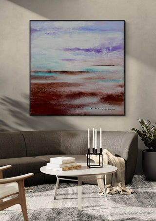 Lavender Haze by Marina Agre in a black frame above a grey sofa with candlesticks