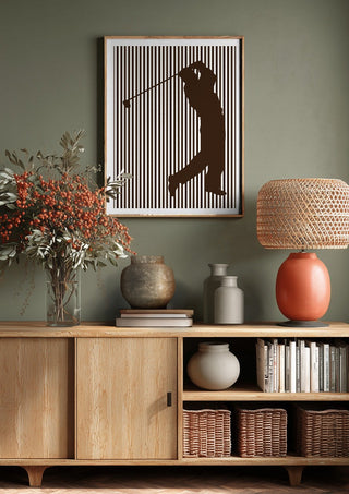 golf sport silhouette by nyai above a wooden sideboard on a sage green wall