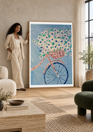 Whimsical Journey in White by Bibi leaning against a sunlit living room wall beside a woman