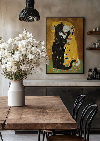 Kitty Kiss by Dikhotomy in a black frame above a rustic table with white flowers