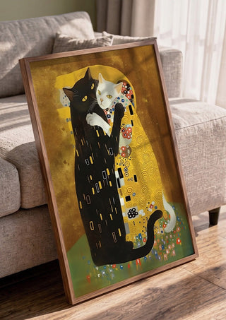 Kitty Kiss by Dikhotomy in a walnut frame leaning against a grey sofa