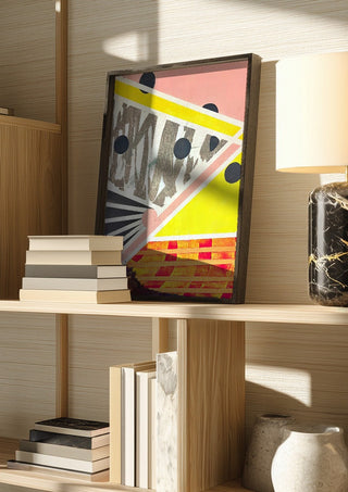 A favourite crossing by Vanyay in a dark frame on a wooden shelf beside books and a lamp