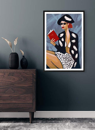 Framed "Red Book Thoughts" by Martina Karlsson hanging above a dark wooden dresser in a modern room.