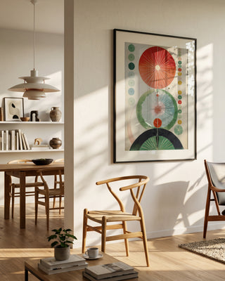 Green Hilma No. 2 poster in a black frame on a white wall above a wishbone chair in a Scandinavian living room.