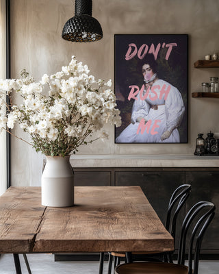 Framed Sassy Lady Pink Bubble - Talitha McQueen art above a rustic table with white flowers in a vase.