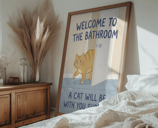 Framed print of a cartoon cat entering a bathroom with the text "Welcome to the Bathroom - A Cat Will Be With You Soon."