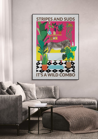 Stripes and Suds wallchart featuring a zebra, plants, and bold patterns displayed above a modern sofa.