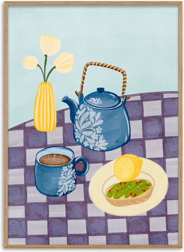 Breakfast table with a teapot, coffee cup, plate of toast with avocado, and vase of flowers on checkered cloth.