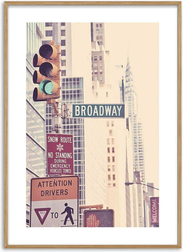 Poster featuring a Broadway street sign with traffic lights and city buildings in the background.