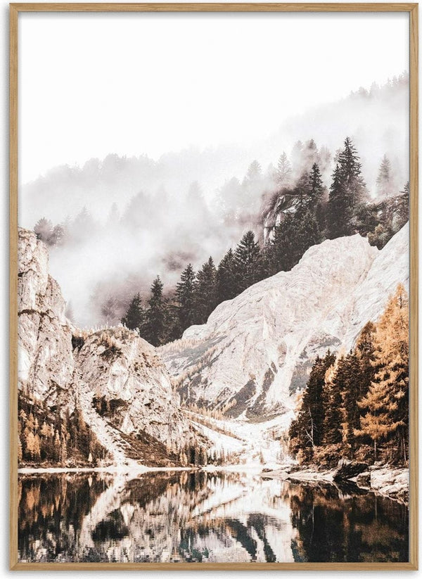Poster of a tranquil mountain lake with mist, rocky cliffs, and pine trees reflected in the water.